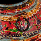 Close up image of a set of 3 round hand-painted iron pots with silver floral designs on blue background, artisanal Indian home accessories and vintage decor accents.
