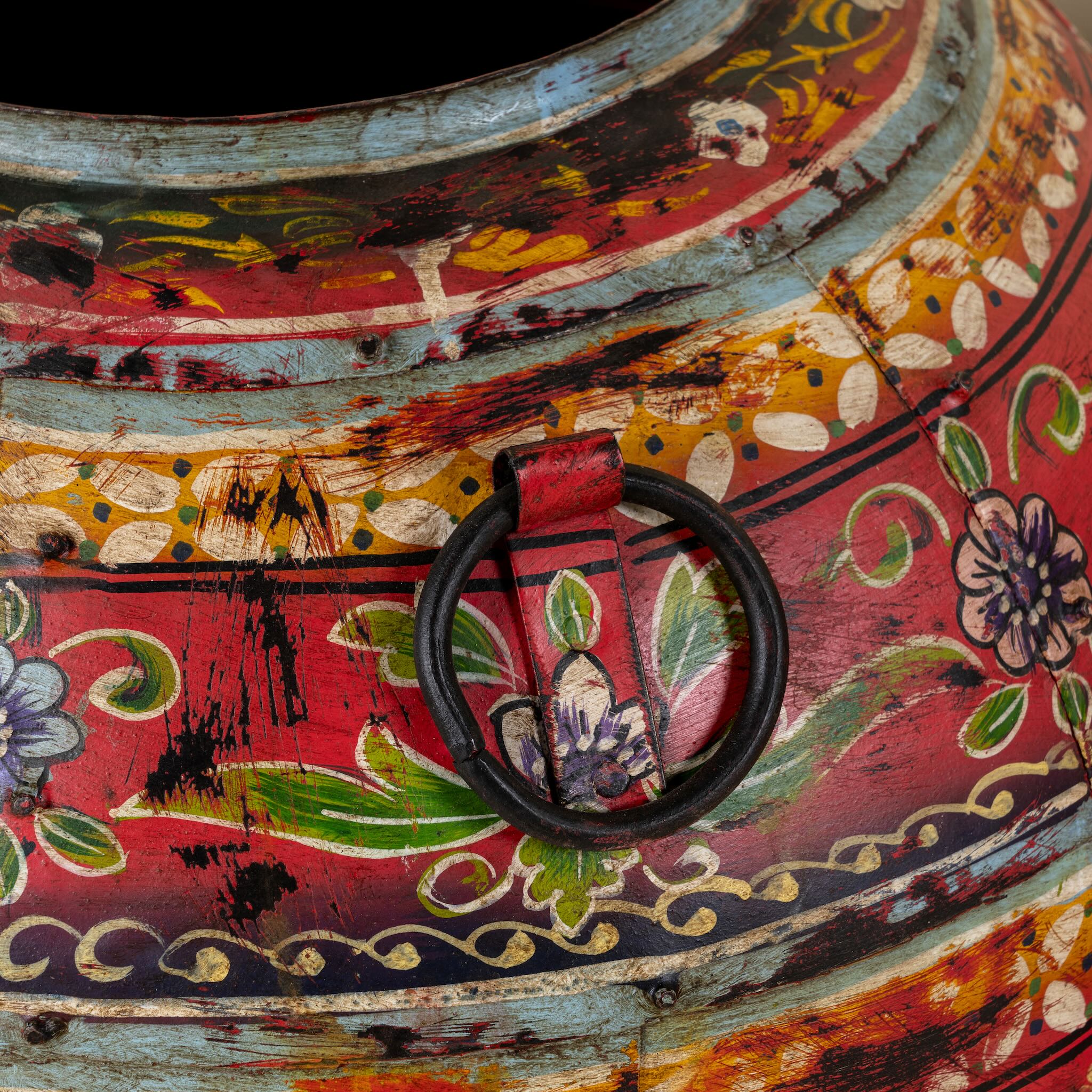 Close up image of a set of 3 round hand-painted iron pots with silver floral designs on blue background, artisanal Indian home accessories and vintage decor accents.