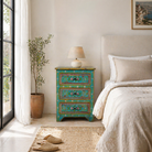 Lifestyle scene with a hand-painted recycled wood nightstand with floral motifs – bold vintage furniture pieces perfect for bohemian and artistic interiors.