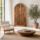 Life style image of a unique wooden wardrobe made from solid mango wood with hand-carved floral design and rounded shape, 100 × 40 × 190 cm.