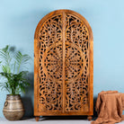 Unique wooden wardrobe made from solid mango wood with hand-carved floral design and rounded shape, 100 × 40 × 190 cm.
