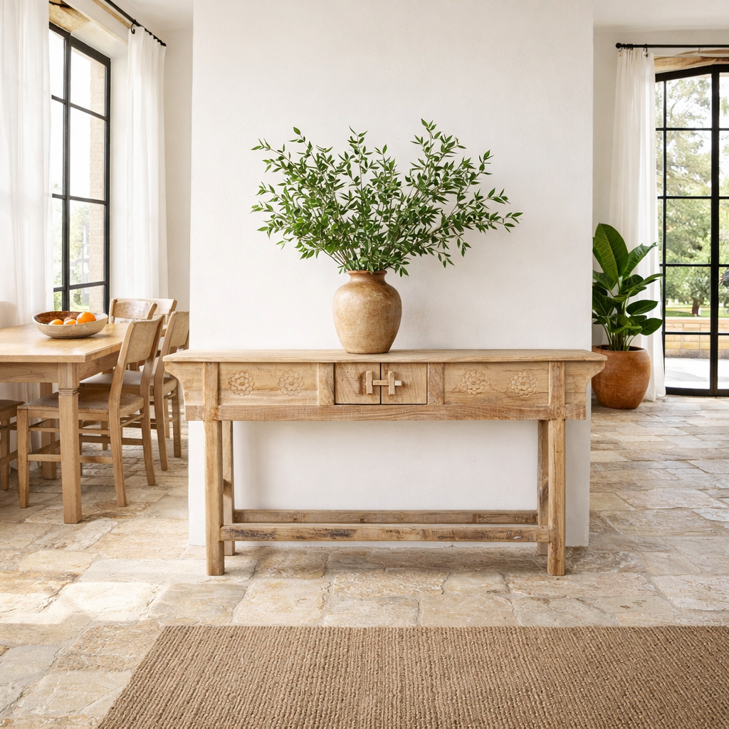 Lifestyle image of a rustic reclaimed teak console table with hand-carved detailing and hidden side compartments; sustainable furniture, 170 × 82 × 48 cm.