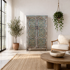 Lifestyle image of a reclaimed wood cabinet with floral and geometric designs, perfect for a bohemian interior with Mediterranean style.
