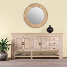 Life style image of a sandblasted mango wood console table with 4 doors and 3 drawers; Mediterranean-style vintage entryway table, water-protected surface, 200 × 42 × 100 cm.