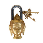 Brass lock with face design and decorative key on a white background