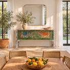 White background image of a hand-painted console table Caara made from reclaimed wood with vibrant elephant motifs and green foliage. A unique furniture piece full of vintage flair for bohemian interiors.