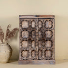 Foldable bar table made of reclaimed teak wood with inside storage and old door front.