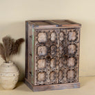 Foldable bar table made of reclaimed teak wood with inside storage and old door front.