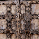 Foldable bar table made of reclaimed teak wood with inside storage and old door front.