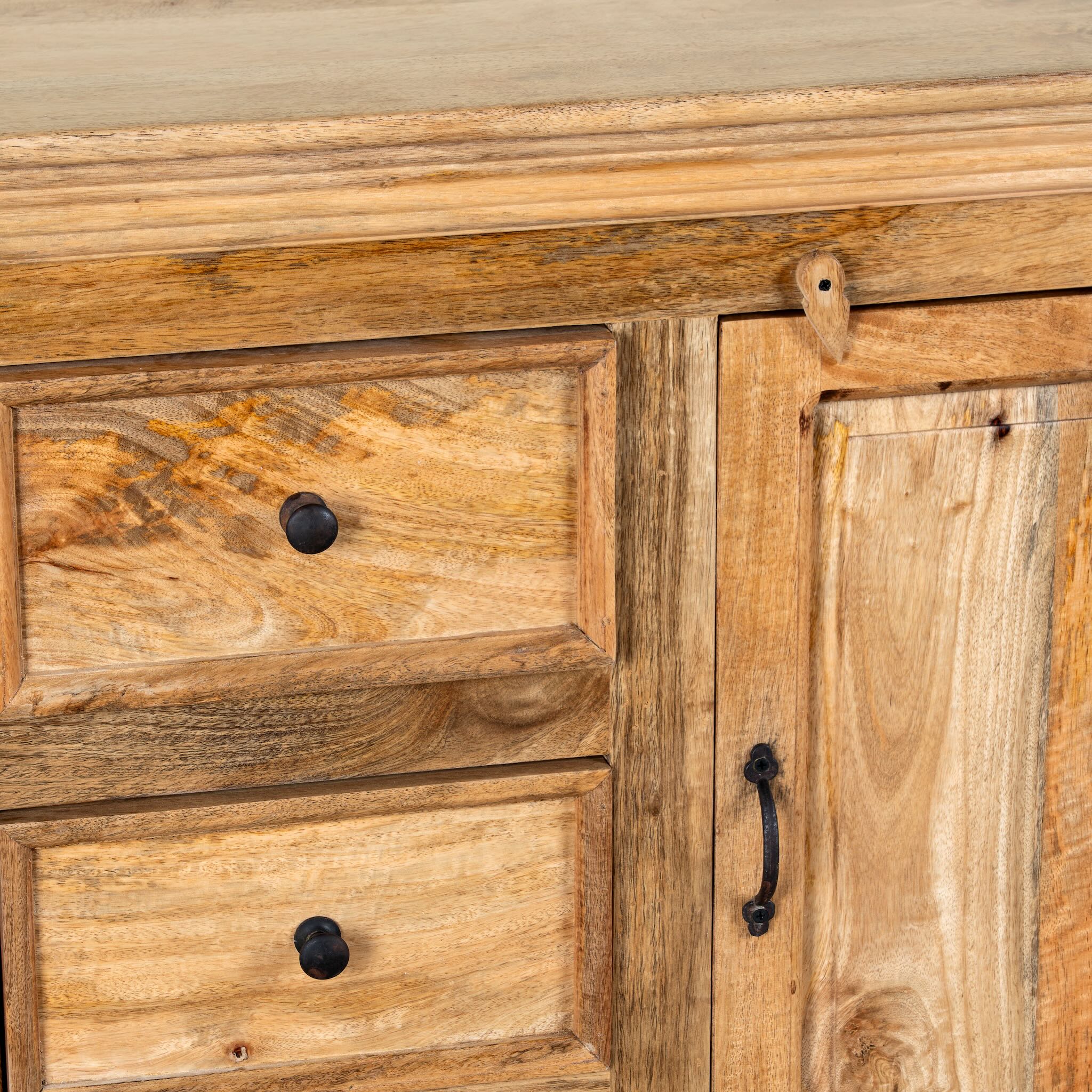 Close up image of a sideboard made of natural mango wood with 2 doors, 4 compartments and 2 drawers. 