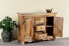 Side angle image with open doors of a sideboard made of natural mango wood with 2 doors, 4 compartments and 2 drawers. 