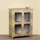 Side angle image of a Chaitanya hand-painted reclaimed wood display cabinet with colourful floral design 112cm
