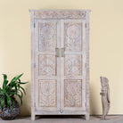 Image of a hand carved mango wood wardrobe in floral design with ample storage in ibiza style.