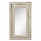 White background image of a tall white washed wall mirror with hand carved wooden mango wood frame; 180 × 90 × 10 cm.