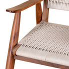 Close up image of a Chameli acacia wood chair with hand-woven cotton rope seat and backrest—an artisan-crafted piece of wooden seating blending comfort and natural materials.