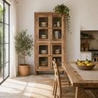 Lifestyle image of Chander tall vitrine with reclaimed teak door panels, a refined piece of teak wood furniture for living room furniture collections.