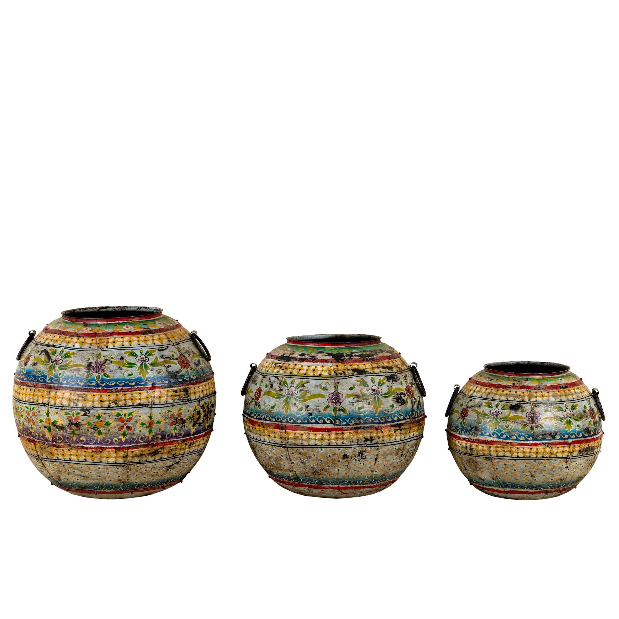 Three decorative vases with mosaic patterns on a white background
