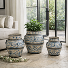 Lifestyle imagination of a set of 3 hand-painted decorative iron pots in cream and blue floral designs, featuring traditional Indian motifs – perfect for vintage home accessories and painted iron decoration.