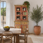 Lifestyle image of a of a hand-painted two-part showcase made of reclaimed wood with floral motifs; unique furniture for a boho chic living room, 94 × 48 × 203 cm.