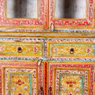 Close up image of a hand-painted two-part showcase made of reclaimed wood with floral motifs; unique furniture for a boho chic living room, 94 × 48 × 203 cm.