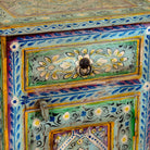 Close up image of a pair of hand-painted nightstands made of reclaimed wood in boho style, sustainable furniture with drawer and cabinet, 45 × 35 × 70 cm.