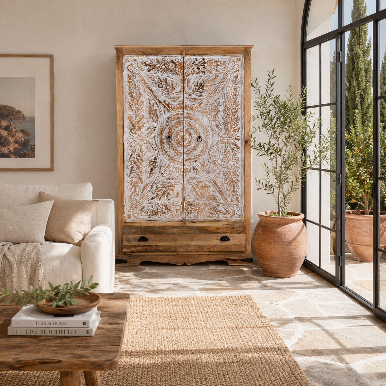 Lifestyle image of a Cheyyur handcrafted solid mango wood wardrobe with hand-carved whitewashed doors, large storage drawer, traditional Indian detailing, and natural wood grain, 190cm.