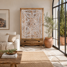 Lifestyle image of a Cheyyur handcrafted solid mango wood wardrobe with hand-carved whitewashed doors, large storage drawer, traditional Indian detailing, and natural wood grain, 190cm.