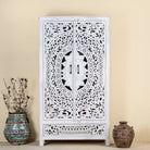 Hand-carved mango wood wardrobe with floral and geometric patterns and white-washed finish – carved wooden furniture for boho chic and Mediterranean-inspired interiors.