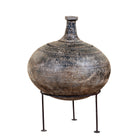 White background image of a hand-painted clay vase with rounded body, narrow neck and iron stand, handcrafted decorative vase with rustic aged finish, 40cm.