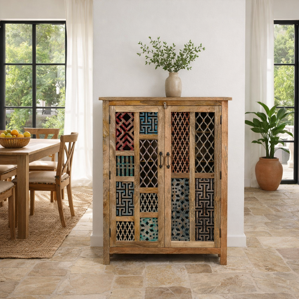 Lifestyle imagination of a artisanal mango wood cabinet with hand-carved floral and geometric lattice doors, distressed finish; ideal for boho style interiors, 100 × 45 × 130 cm.