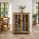 Lifestyle imagination of a artisanal mango wood cabinet with hand-carved floral and geometric lattice doors, distressed finish; ideal for boho style interiors, 100 × 45 × 130 cm.