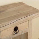 Close up image of a teak wood console table with sandblasted finish, three drawers and lower shelf; sustainable furniture for entryways, living rooms, or bathrooms, 160 × 30 × 80 cm.
