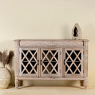 Rustic sideboard made of Mango wood with hand-carved details and glass panelled doors featuring a diamond lattice design.