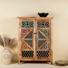 Handmade mango wood cabinet with carved floral and geometric lattice doors, distressed colour accents; artisanal furniture perfect for boho style interiors, 100 × 45 × 130 cm.