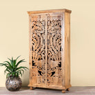 Side angle image of a hand-carved mango wood cupboard with Indian peacock design motifs, Mediterranean-style wardrobe; elegant mango wood furniture, 190 × 100 × 40 cm.
