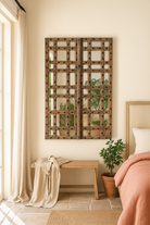 Liefestyle image of a reclaimed teakwood mirror crafted from an antique Indian door panel, featuring iron accents and mirror inlays – ideal for vintage home decor and heritage-inspired interiors.