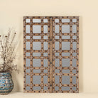 Reclaimed teakwood mirror crafted from an antique Indian door panel, featuring iron accents and mirror inlays – ideal for vintage home decor and heritage-inspired interiors.