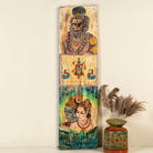 Hand-painted vintage door panel measuring 52x3x152 cm, featuring detailed depictions of Hindu deities—Hanuman at the top, a divine scene with attendants in the center, and a serene portrayal of Lord Shiva with Parvati at the bottom—rendered on distressed wood for a timeworn, sacred aesthetic.
