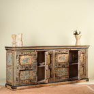 Open door image of a unique sideboard made of recycled wood with hand painted Indian motifs in blue and gold; sustainable furniture for dining rooms or hallways, 220 × 44 × 98 cm.