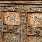 Close up image of a unique sideboard made of recycled wood with hand painted Indian motifs in blue and gold; sustainable furniture for dining rooms or hallways, 220 × 44 × 98 cm.