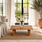 Lifestyle image of a handcrafted reclaimed wood coffee table with rounded edges and rustic grain; perfect for rustic interiors, 120 × 90 × 48 cm.
