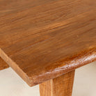 Close up picture of a handcrafted reclaimed wood coffee table with rounded edges and rustic grain; perfect for rustic interiors, 120 × 90 × 48 cm.