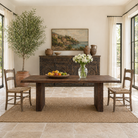 Lifestyle image of a rustic reclaimed wood log dining table with block legs, sustainable furniture design, 240×100×75 cm.