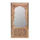 White background image of a hand-carved mirror crafted from an old teak wood window frame, featuring intricate floral and scrollwork details with a natural distressed finish and an arched top design reflecting traditional Indian craftsmanship.
