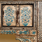 Close up image of a  hand painted console table in reclaimed teak with floral motifs and antique distressed finish, 197 × 40 × 82 cm.