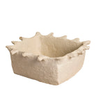 White backround image of a handmade papier-mâché bowl Dityaa in matte white with jagged edges. A sustainable vintage home accessory perfect for unique Indian decoration and vintage home decor, used in bathrooms, kitchens, or for dried plants.