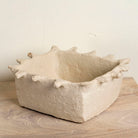 Handmade papier-mâché bowl Dityaa in matte white with jagged edges. A sustainable vintage home accessory perfect for unique Indian decoration and vintage home decor, used in bathrooms, kitchens, or for dried plants.