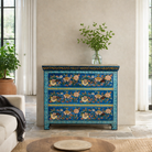 Lifestyle imagination of a hand-painted cupboard made of reclaimed wood with floral drawer fronts – Divisha model by Om Home & Garden