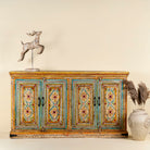 Image of a hand painted wooden dresser with floral and geometric motifs, reclaimed wood living room furniture in vintage boho style, 170 × 45 × 95 cm.