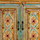 Close up image of a hand painted wooden dresser with floral and geometric motifs, reclaimed wood living room furniture in vintage boho style, 170 × 45 × 95 cm.